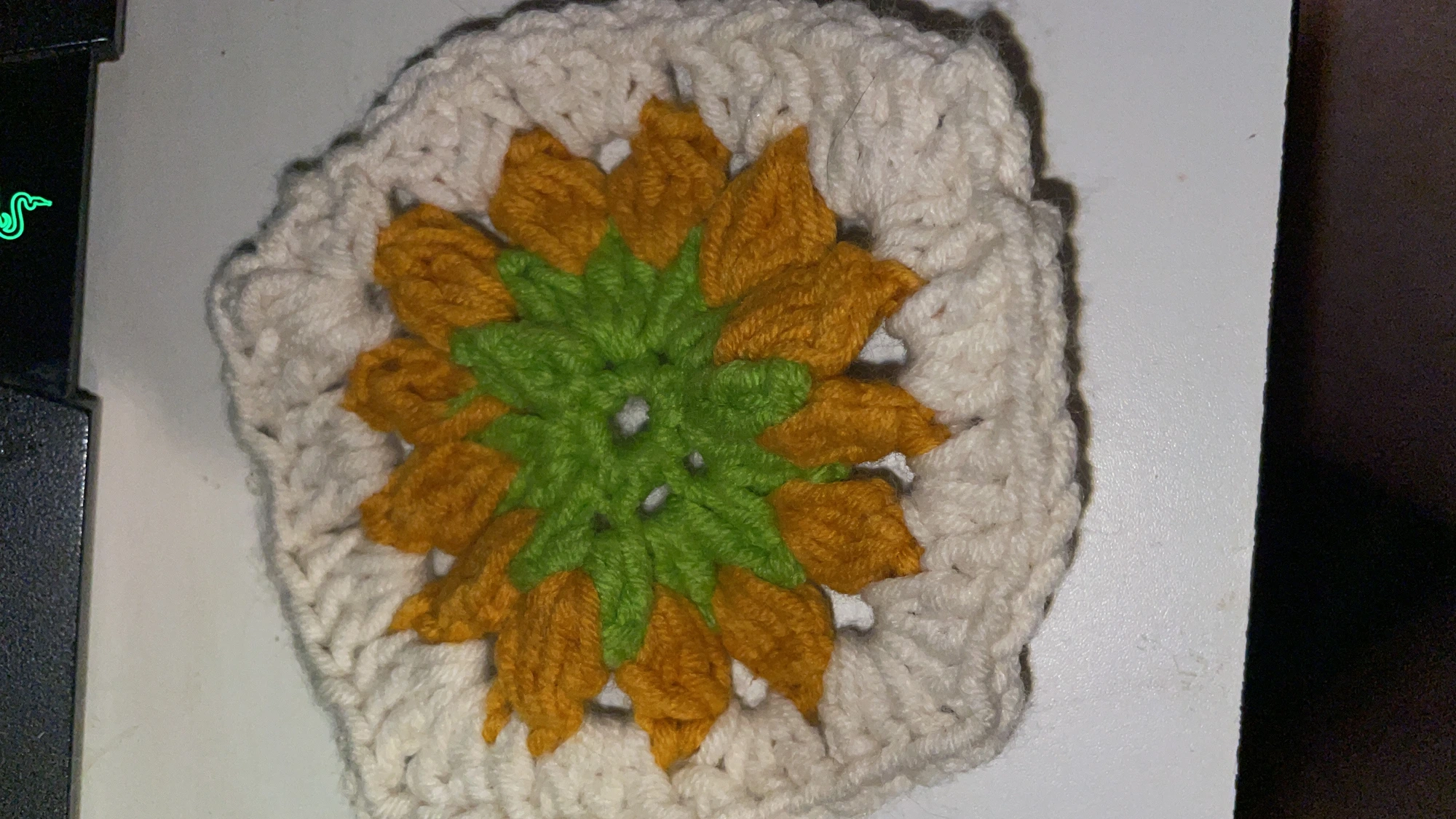 Crochet flower coaster in cream, mustard and green, made by Els